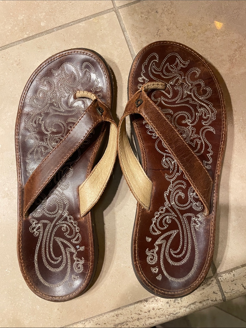 OluKai Brown Leather Flip-Flops with Tan Straps and Embroidered Footbed